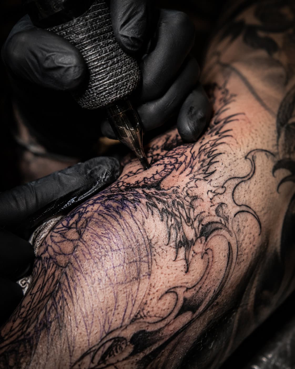 An artist's hand mid-line over fresh work.